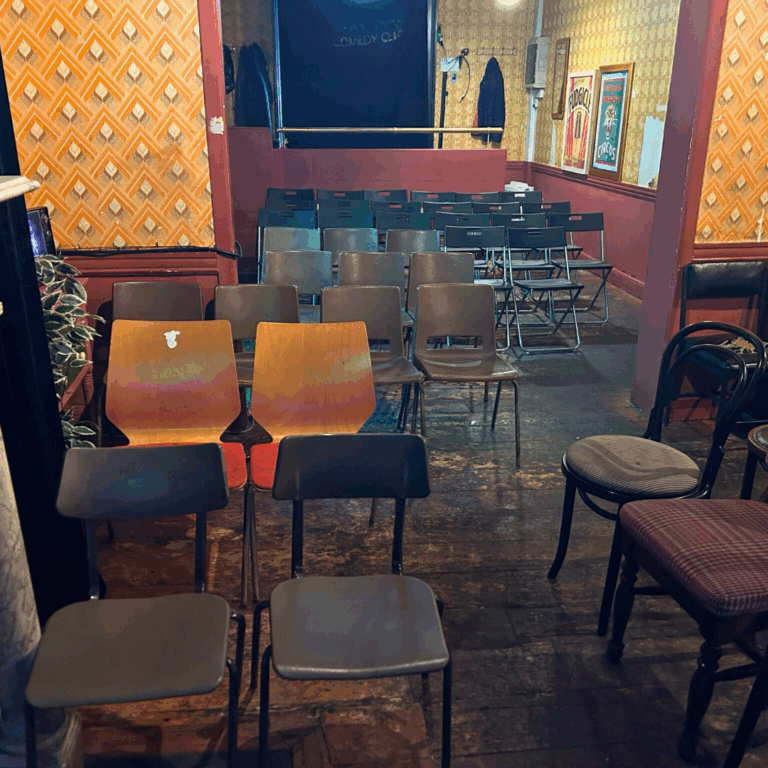 Craic Den Comedy Club audience seating of assorted chairs in rows