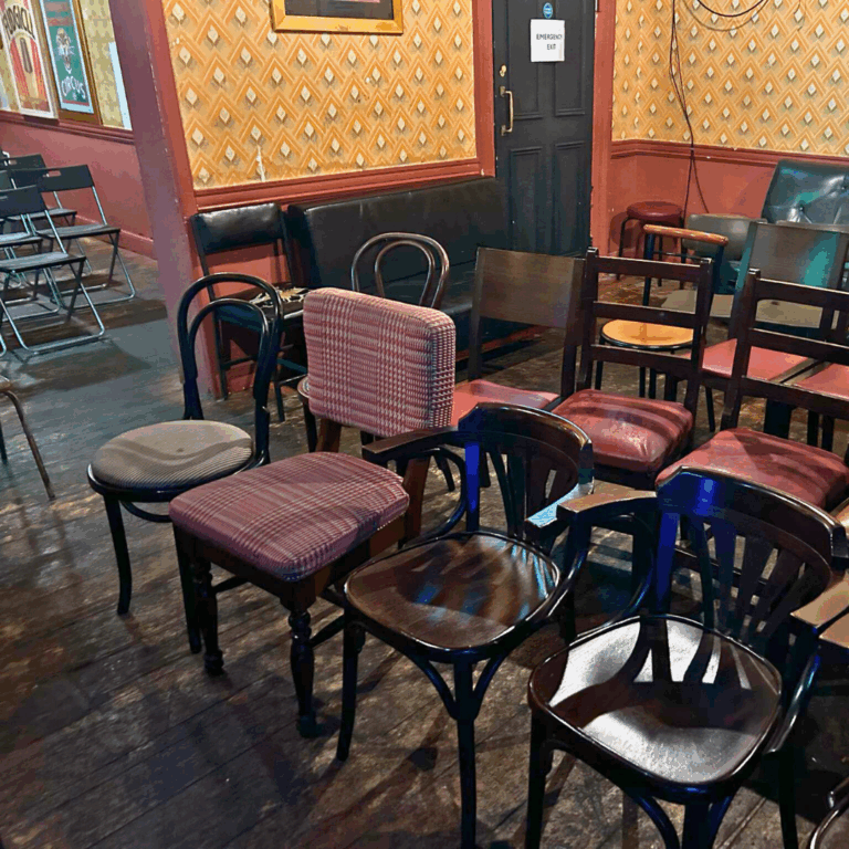 Craic Den Comedy Club audience seating of assorted chairs in rows
